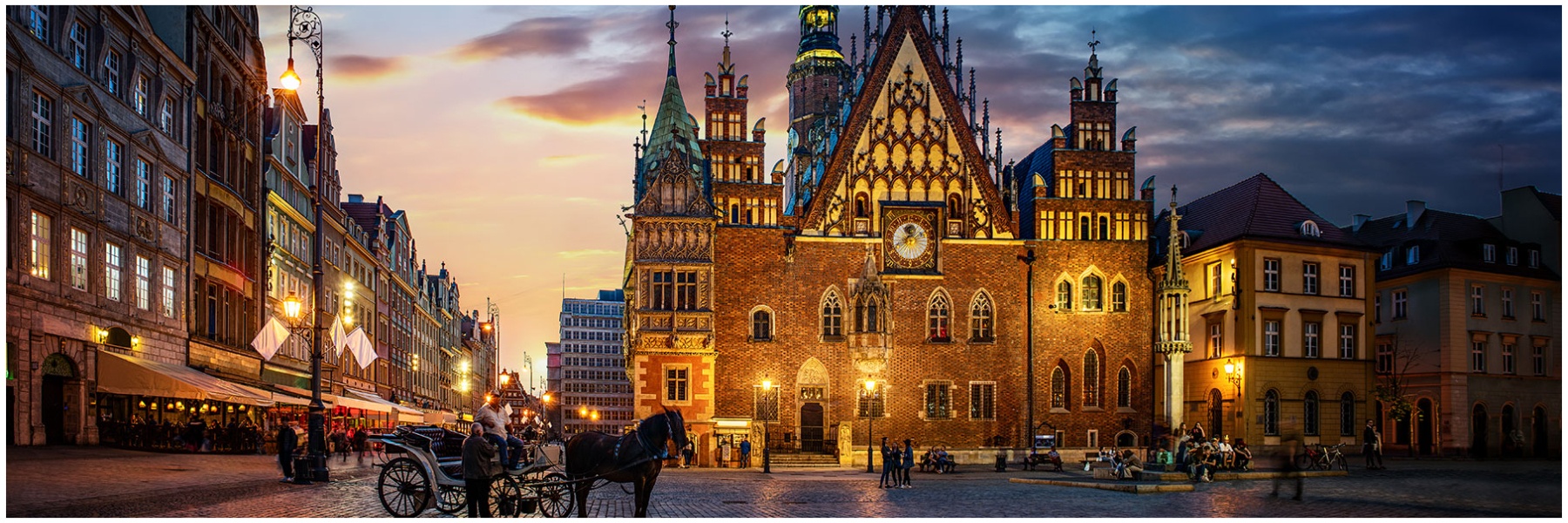 A streetscape in Poland, with a horse and carriage in front of a church.